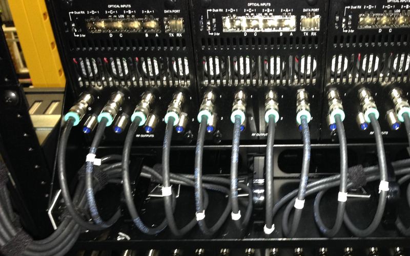 Labeled coax jumpers connected to rack-mounted equipment