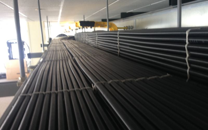 Armored cables laced in neat rows on overhead ladder rack