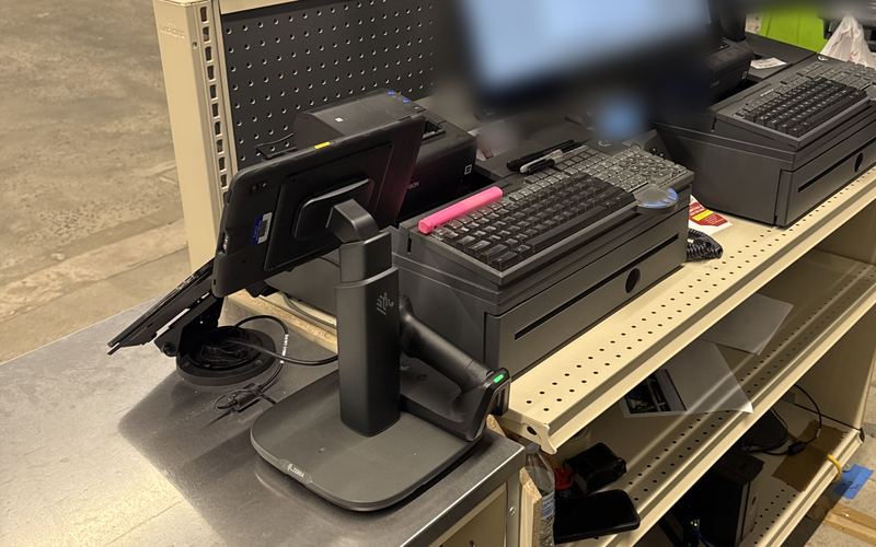 Two retail checkout lanes with POS keyboards and card terminals