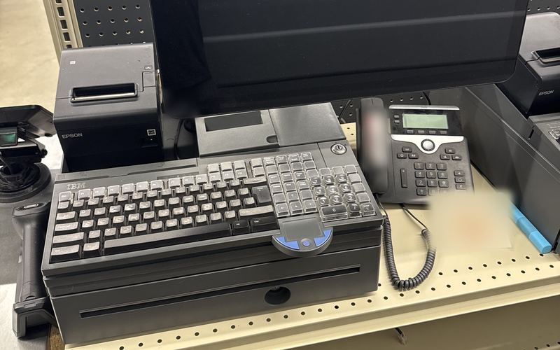 Retail POS register station with receipt printer, POS keyboard and VoIP desk phone