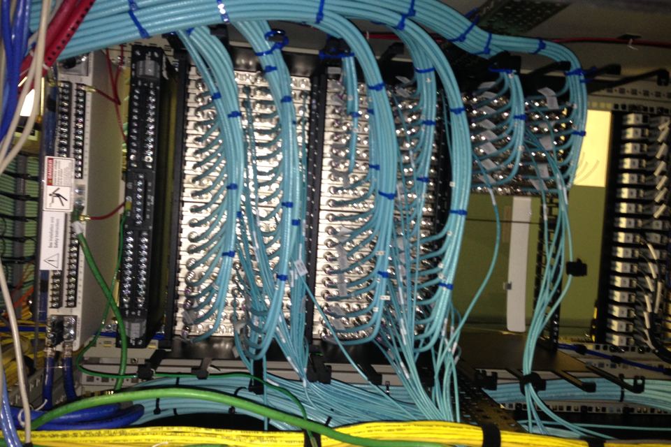 Telecom rack with neatly dressed and tied network cables, fiber and ground wire